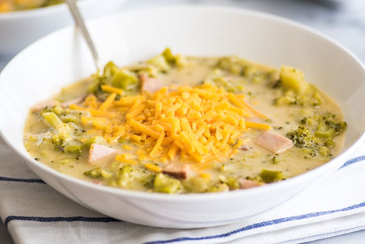 Broccoli chowder in a white bowl.