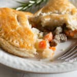 Beef pasty broken open on a white plate.