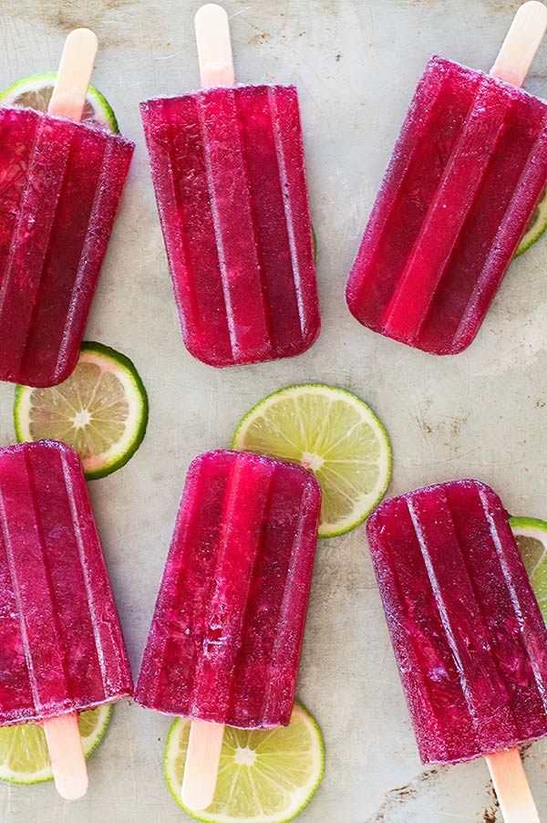Super easy Tinto De Verano red wine popsicles made with your favorite red wine, lemon lime soda, and a homemade lime simple syrup. Delicious, boozy treats perfect for a grown-up summer. Recipe includes nutritional information. From BakingMischief.com
