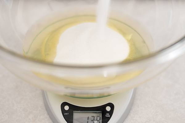 Sugar being poured into egg whites for marshmallow frosting.