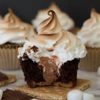 These are the perfect s'mores cupcakes: a graham cracker base, soft and decadent chocolate cake, gooey Hershey's chocolate buttercream center, and toasted marshmallow frosting. Recipe includes nutritional information. From BakingMischief.com