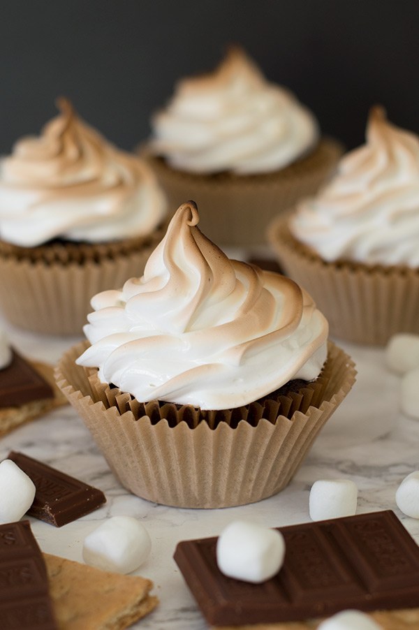 These are the perfect s'mores cupcakes: a graham cracker base, soft and decadent chocolate cake, gooey Hershey's chocolate buttercream center, and toasted marshmallow frosting. Recipe includes nutritional information. From BakingMischief.com