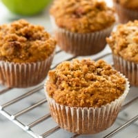 Tender apple crumb muffins with caramelized cinnamon apples and a crunchy crumbly brown sugar crumb topping. Recipe includes nutritional information. From BakingMischief.com
