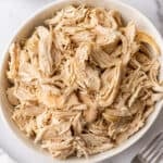 Shredded chicken in a white bowl.
