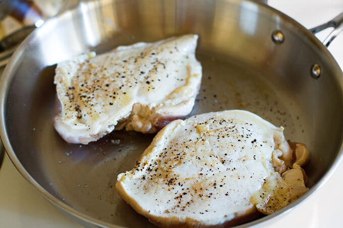 Chicken browning in a pan so it can be shredded. 