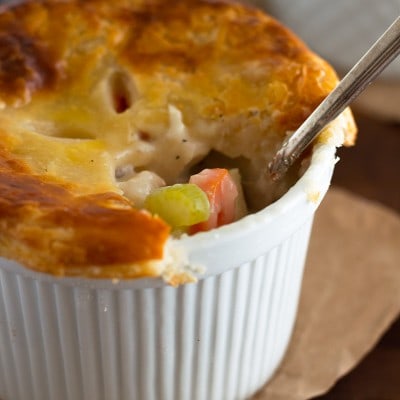 These Individual Chicken Pot Pies are easy to make, stuffed with chicken, carrots, and celery, and topped with a delicious flaky buttermilk crust.