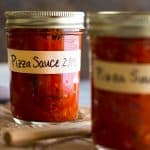 Homemade pizza sauce in mason jars for storage.