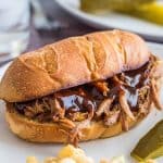 Slow cooker tri-tip sandwich on a white plate.