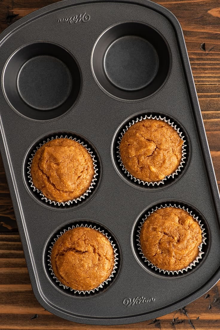 Overhead photo of small batch of pumpkin cupcakes in a baking pan.