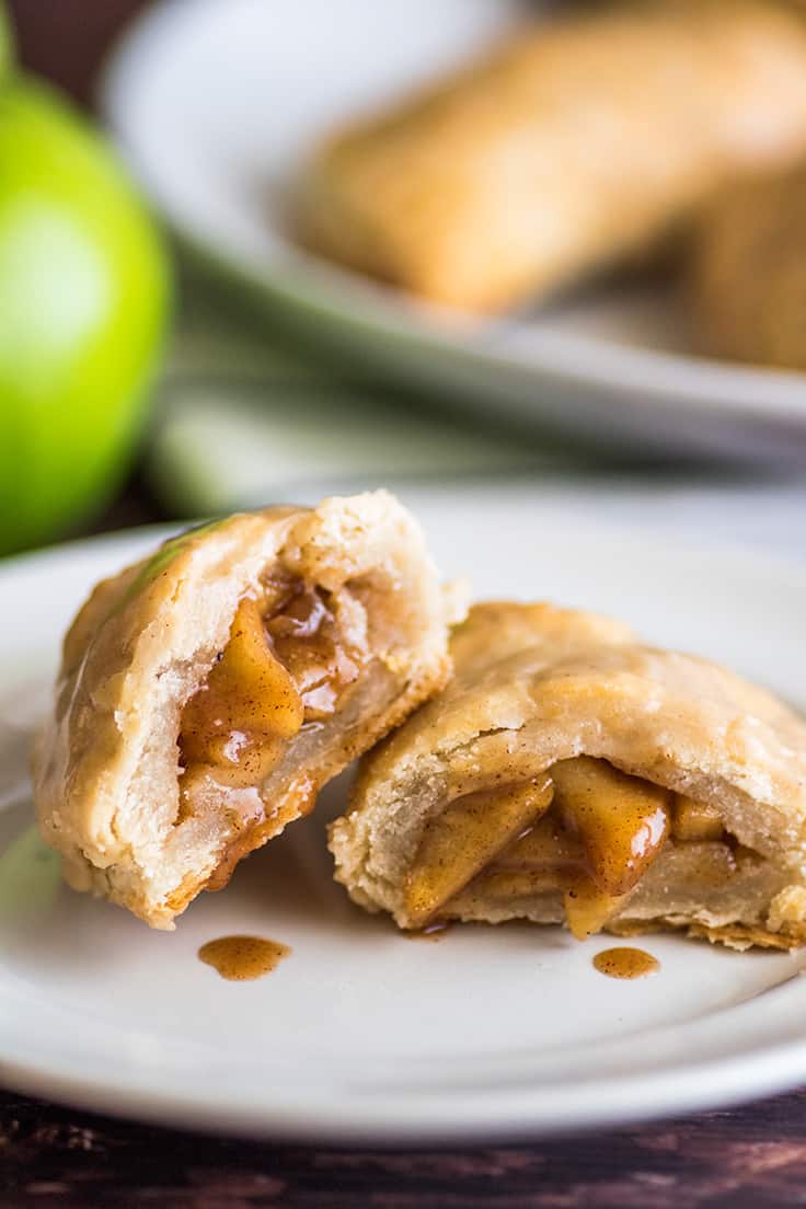 Close up of apple hand pie split open on a plate.