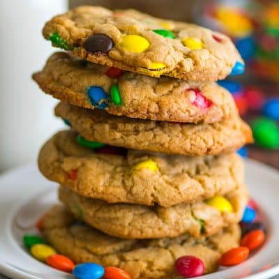 Stack of small-batch M&M Cookies on a white plate.