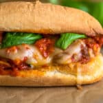 Meatball sandwich on parchment paper.