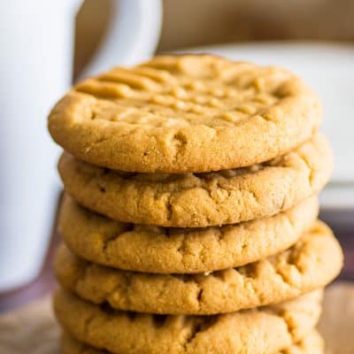 Stack of small-batch peanut butter cookies on parchment paper.