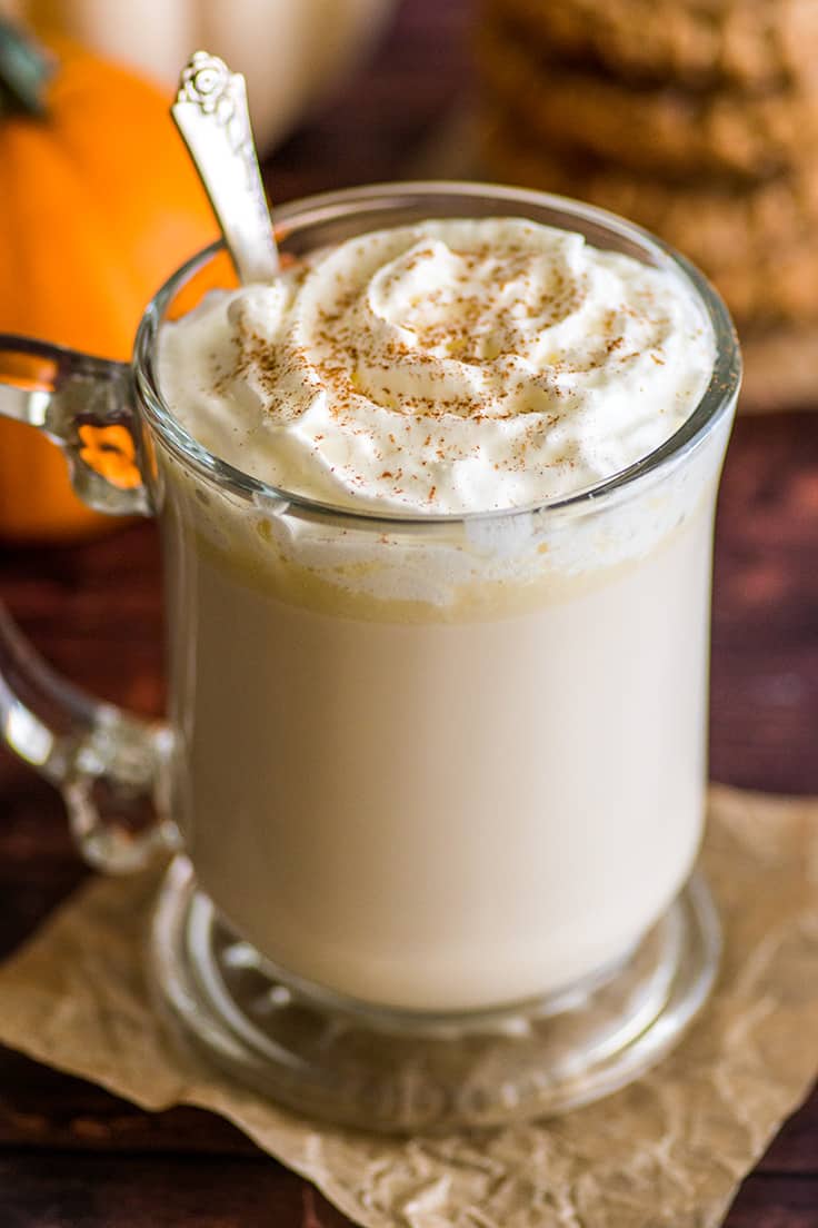 A glass of Chai White Hot Chocolate with whipped cream.
