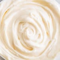 This Small-batch Cream Cheese Frosting recipe is silky smooth, tangy, and very cream cheesy! | #frosting | #creamcheese | #dessert |