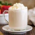 Photo of homemade white chocolate mocha with whipped cream and white chocolate shavings.