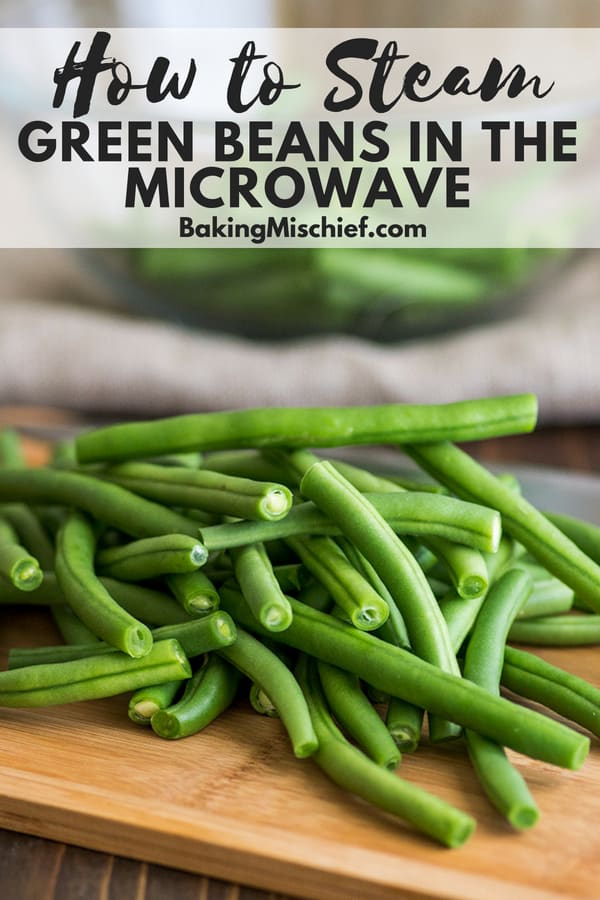 Fresh green beans on a cutting board with text overlay: How to Steam Green Beans in the Microwave.