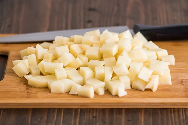 Mashed Potatoes for Two Photo Step 2: chopped potatoes on a cutting board.