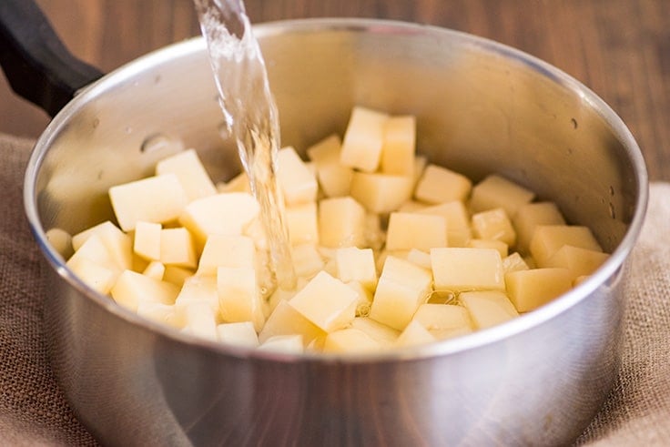 Mashed Potatoes for Two Photo Step 3: cold water being added to cubed potatoes.