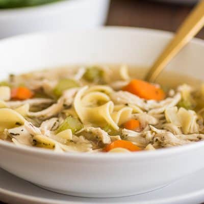 Feature photo of Easy Chicken Carcass Soup in a white bowl.