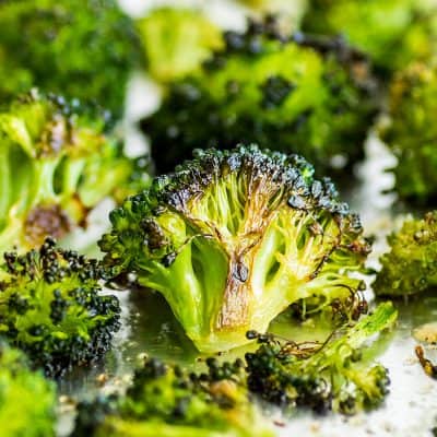 Crispy oven-roasted broccoli on a baking sheet.