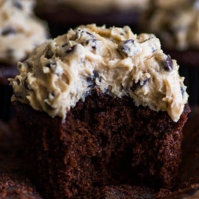 Photo of a Chocolate Cookie Dough Cupcake with a bite out of it.