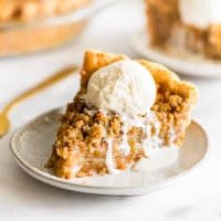 Picture of a slice of Dutch Apple Pie with vanilla ice cream on top.