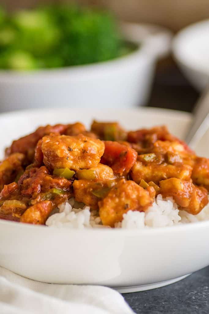 This easy chicken curry is an all-time favorite in my family and a super quick and simple weeknight meal. | #chickencurry | #chicken | #bonelessskinlesschickenbreasts | Picture of Easy Chicken Curry over rice in a white bowl.