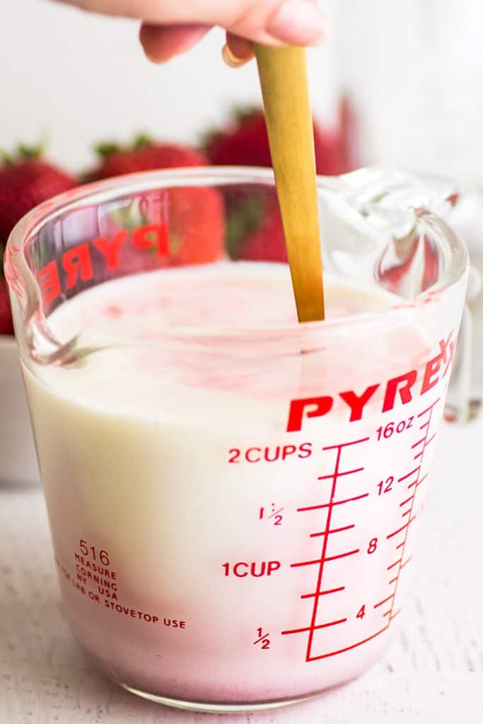 Photo of homemade strawberry milk being mixed up.