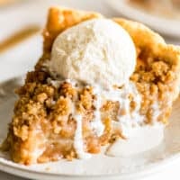 Picture of a slice of Dutch Apple Pie with vanilla ice cream on top.