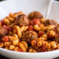 Square photo of Homemade Spaghettios in a white bowl.