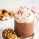Picture of Easy Peppermint Mocha in a mug next to gingerbread cookies.