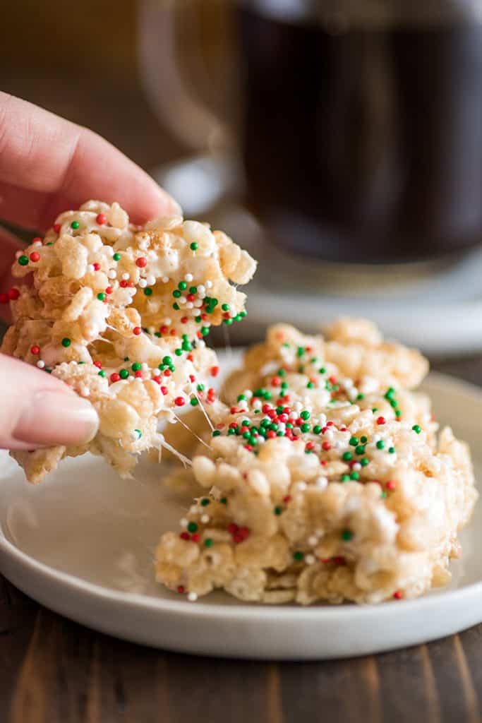 Picture of rice krispie treat for one with Christmas sprinkles being pulled apart.