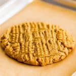 Picture of giant one peanut butter cookie on a quarter sheet baking tray.