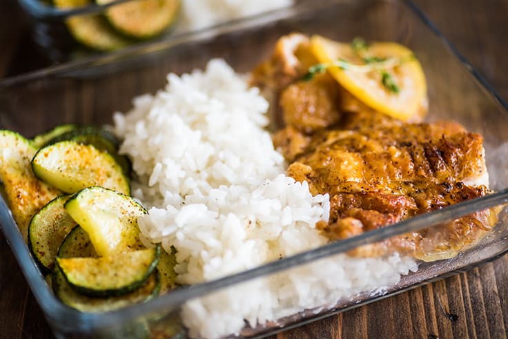 Chicken thighs in meal prep container.