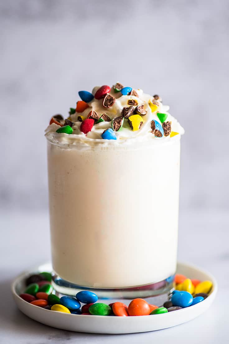 Vanilla Milkshake in Plastic Glass on a Dark Background. Vanilla