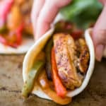 Chicken fajita being picked up.