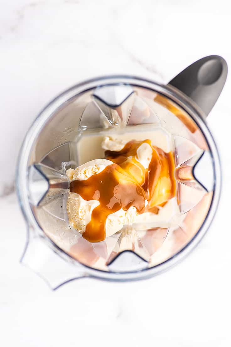 Overhead photo of caramel shake being made in a blender.
