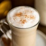 Chai tea latte in a glass mug.