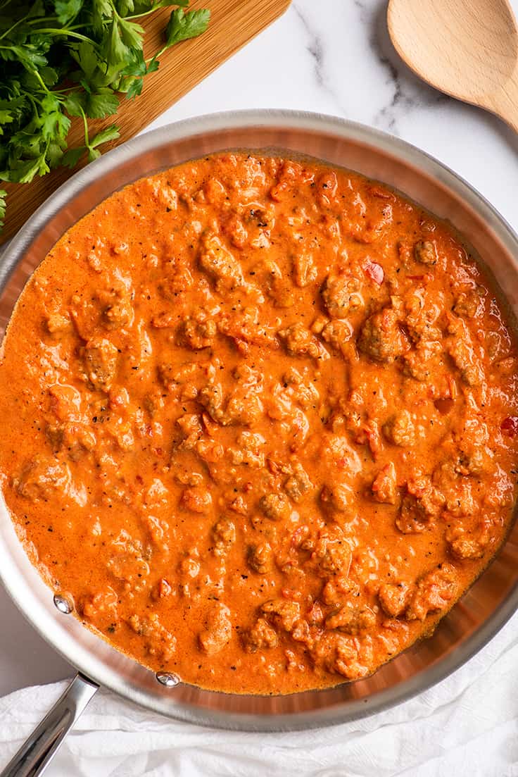 Creamy sausage pasta sauce in a skillet.