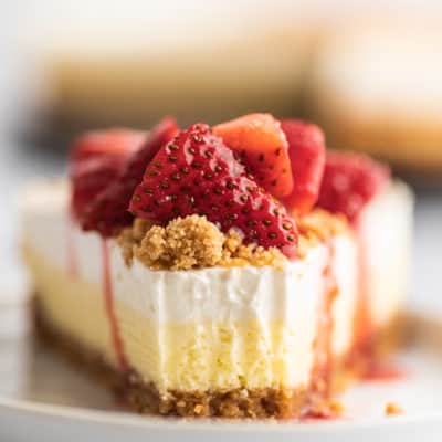 Slice of cheesecake with a bite out of it.