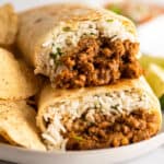 Close up photo of freezer burritos stacked on a plate.