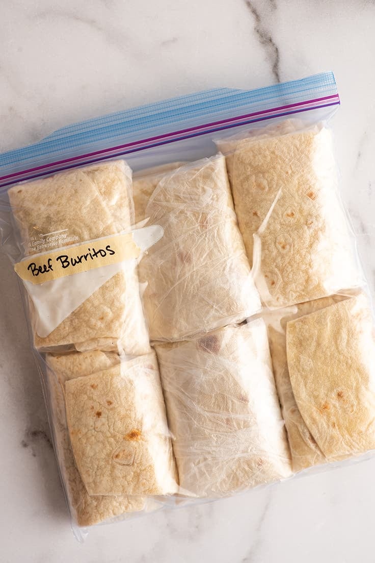 Freezer burritos in a freezer bag ready for freezing.