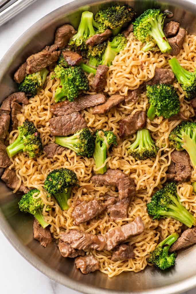 Broccoli beef ramen in a skillet.