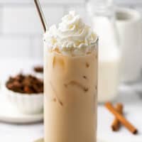 Iced chai tea latte in a glass cup.