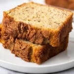 One banana banana bread slices on a white plate.
