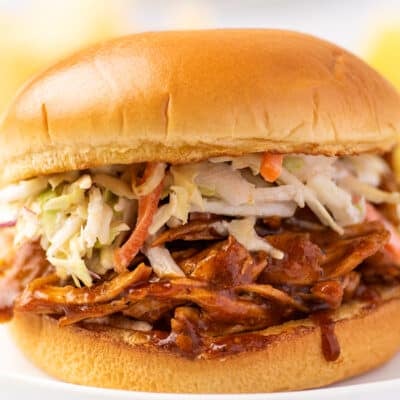 BBQ chicken sandwich on a white plate.