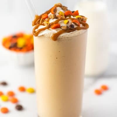 Peanut butter milkshake in a glass cup.