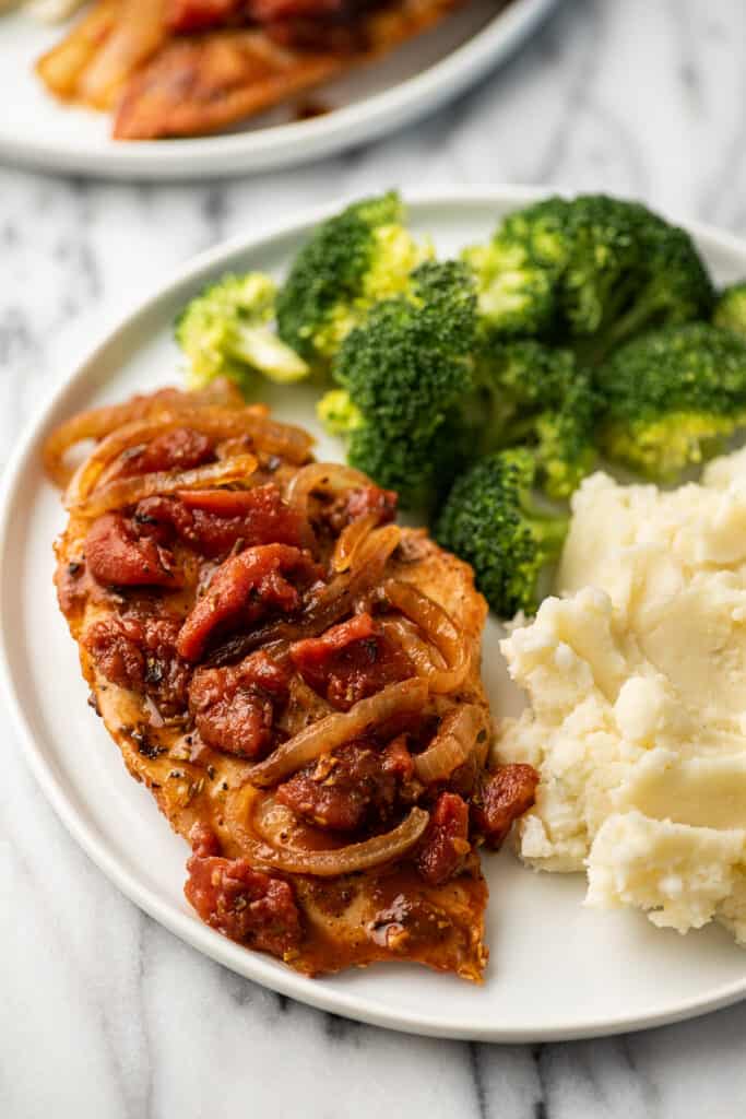 Balsamic chicken on a plate with mashed potatoes.
