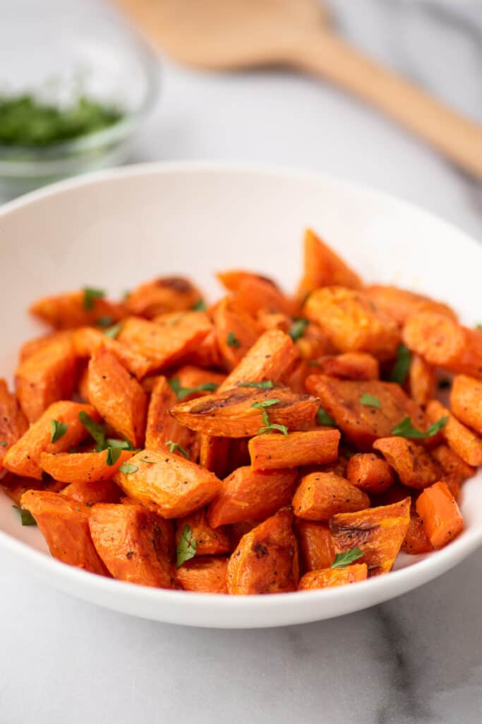 Roasted carrots in a white bowl.